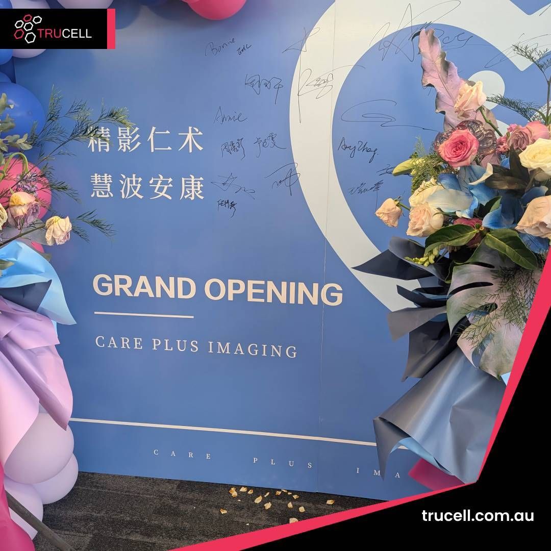 Care Plus Imaging Doncaster grand opening backdrop with floral arrangements and signed messages from the launch event