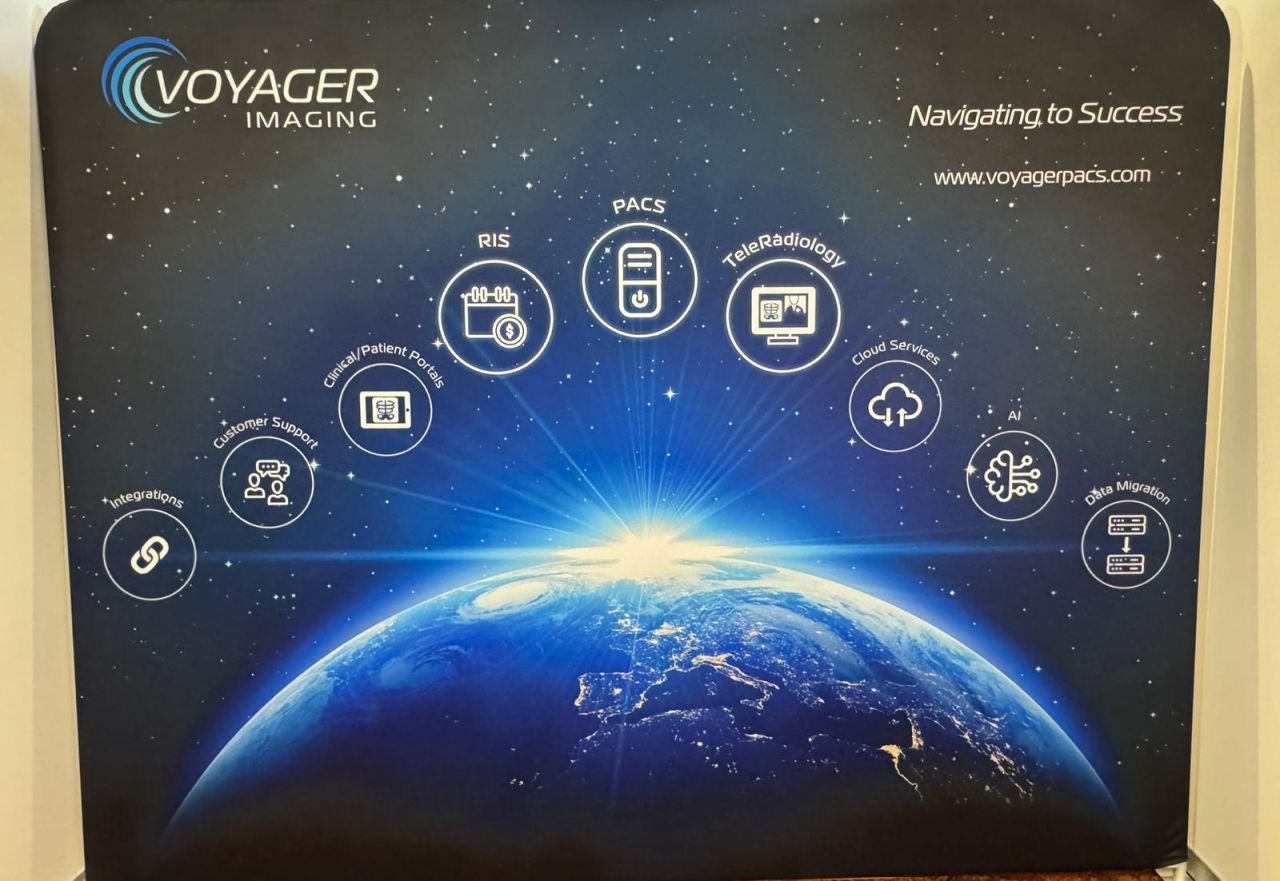 Voyager Imaging booth at RANZCR NZ ASM 2025 with dual-monitor demo workstation, pull-up banner, and the full-stack backdrop